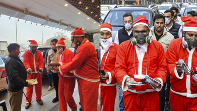 NSUI volunteers dressed as Santa Claus with gas masks (PTI)